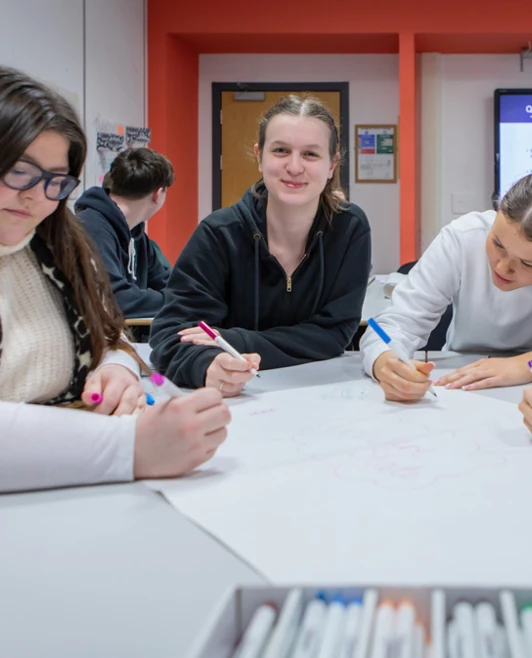 A vibrant snapshot of Glasgow Kelvin College students working together, sharing thoughts and smiles in a supportive classroom setting. A vibrant snapshot of Glasgow Kelvin College students working together, sharing thoughts and smiles in a supportive classroom setting.